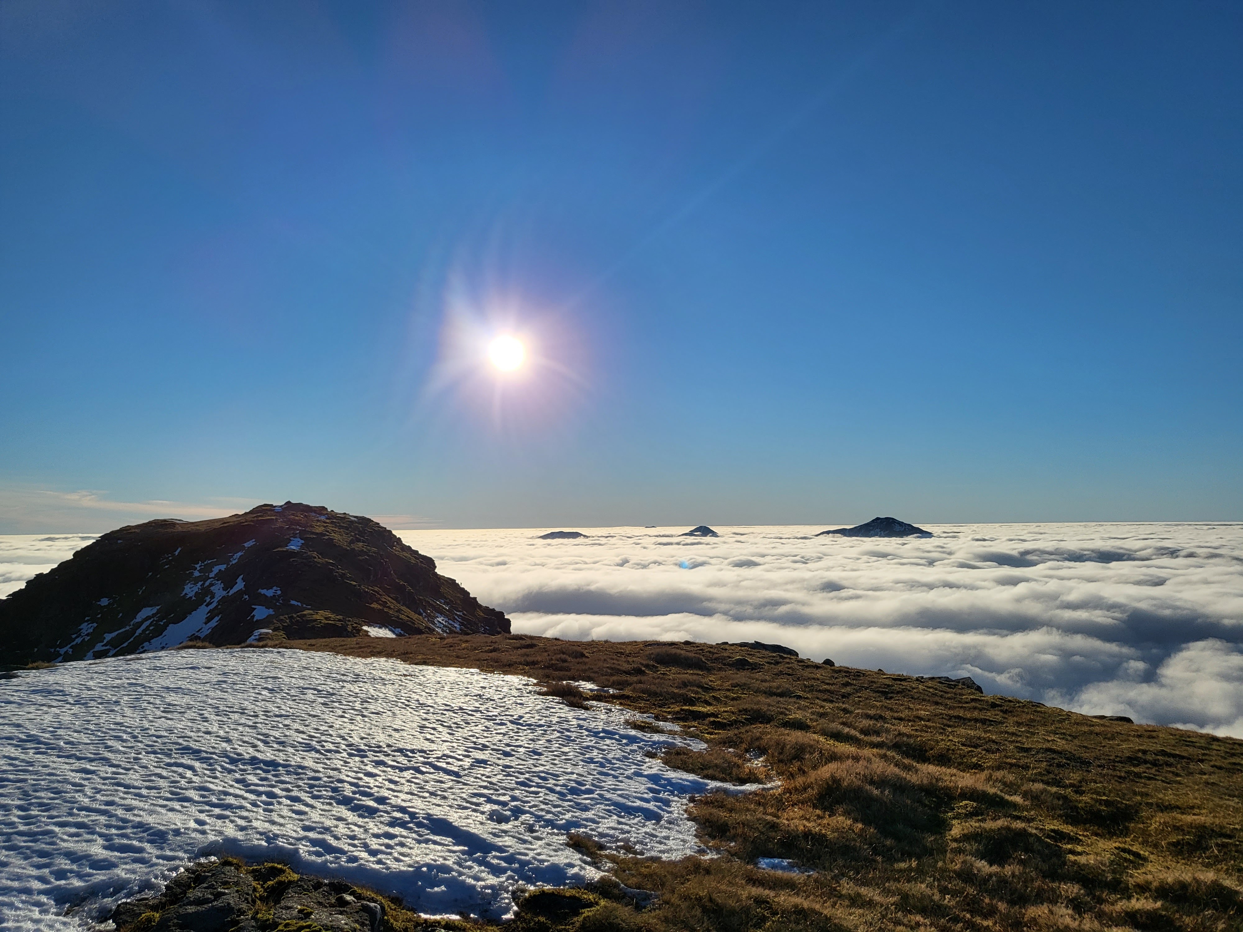 Mountain above the clouds in the sun