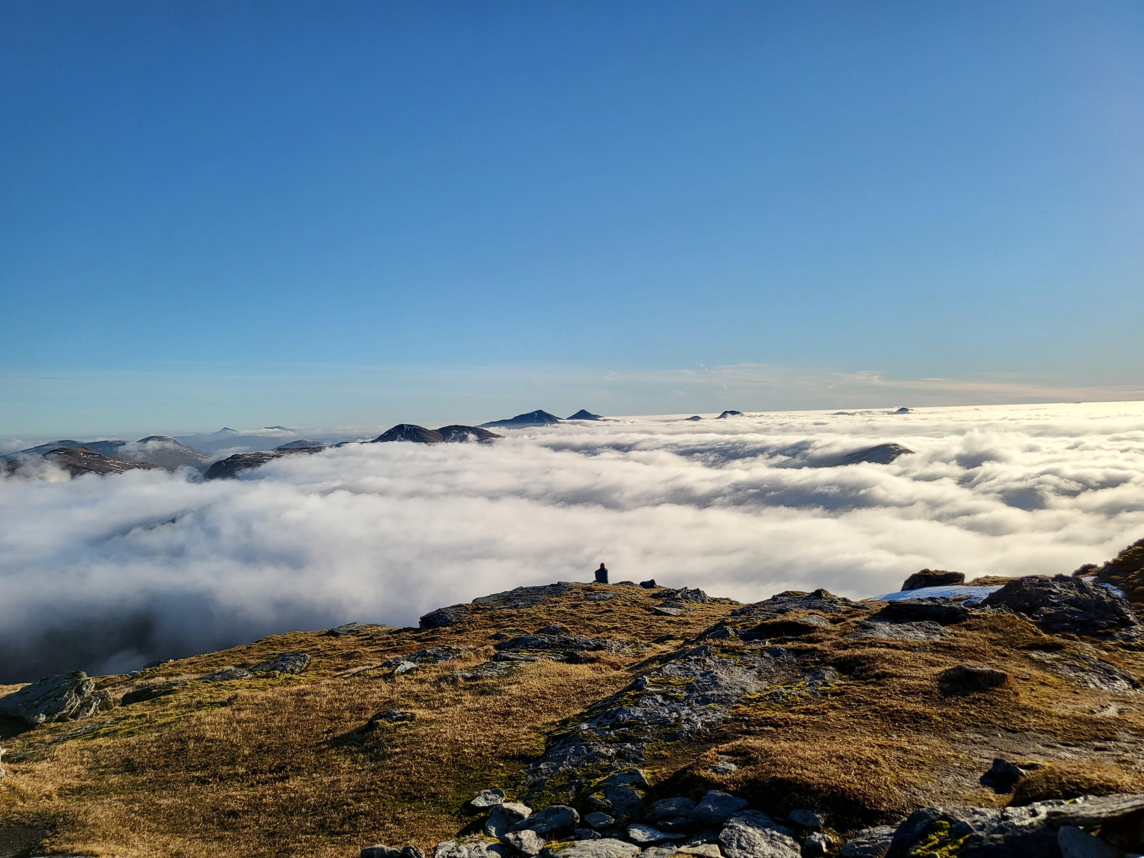 Paraglider looking over the clouds above Scotland's A82 from Tyndrum to Bridge of Orchy