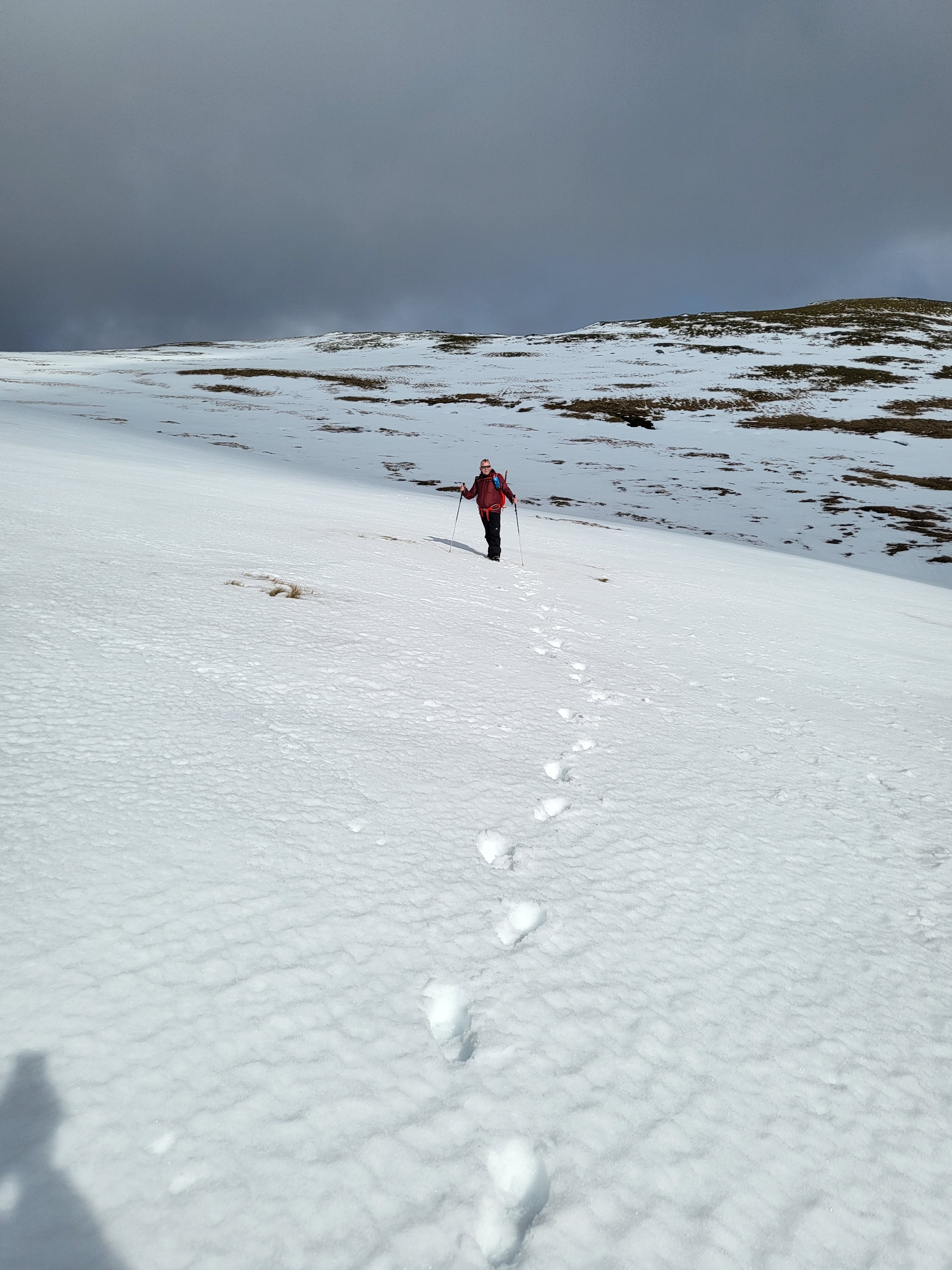 Lone hiker walking in the snow.