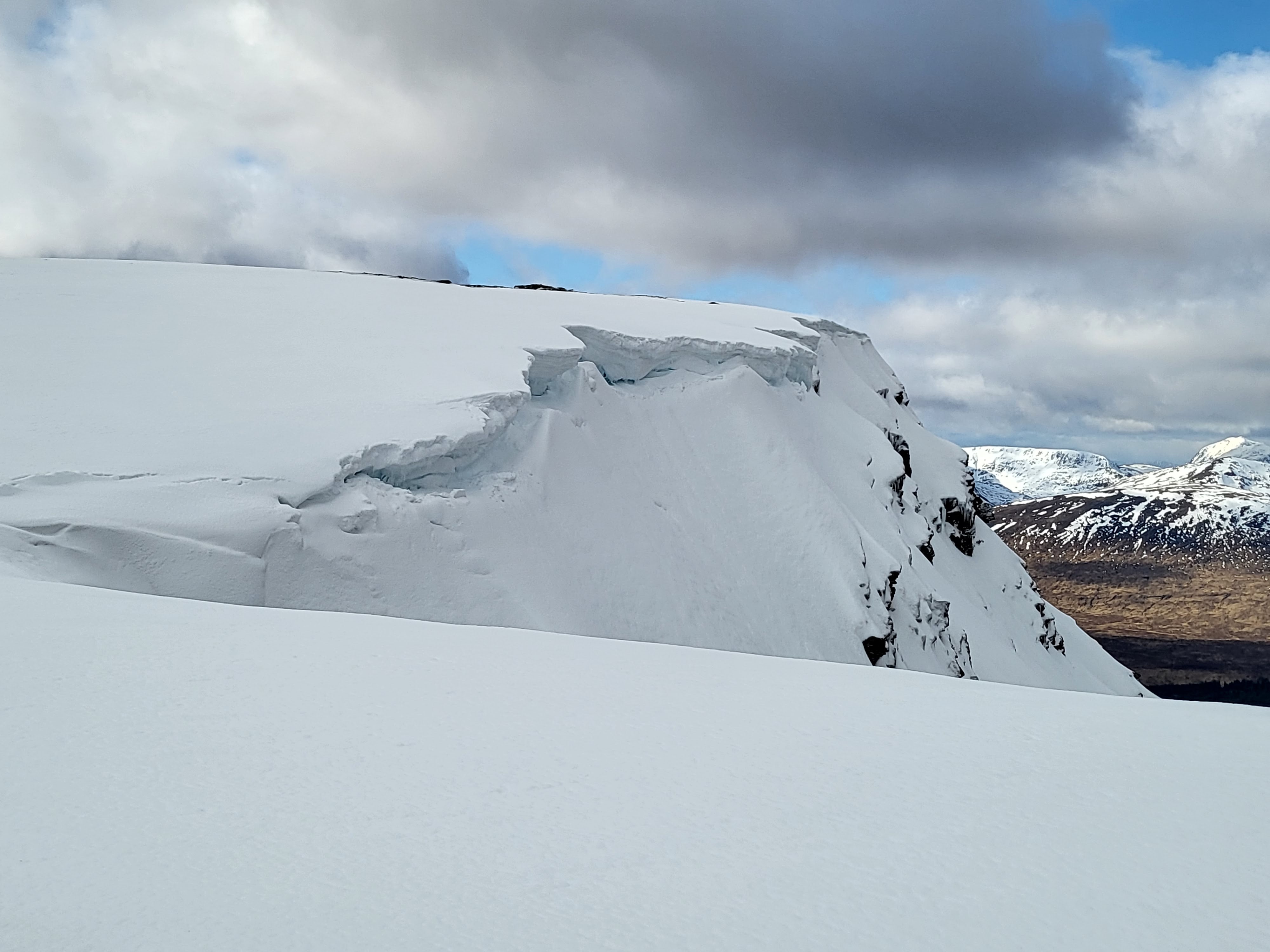 Cornice with snow capped mountains in the distance