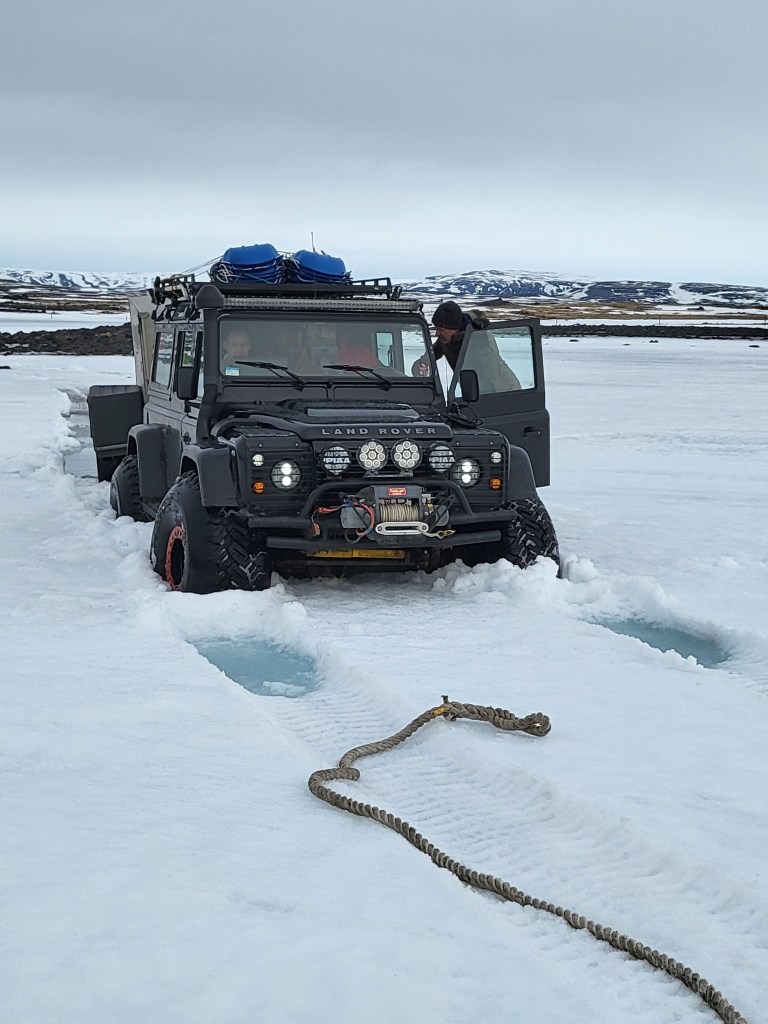 Land Rover sinking in deep snow.