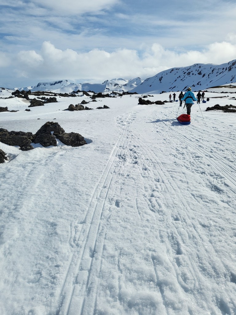Trekkers in winter mountains with snowshoes.