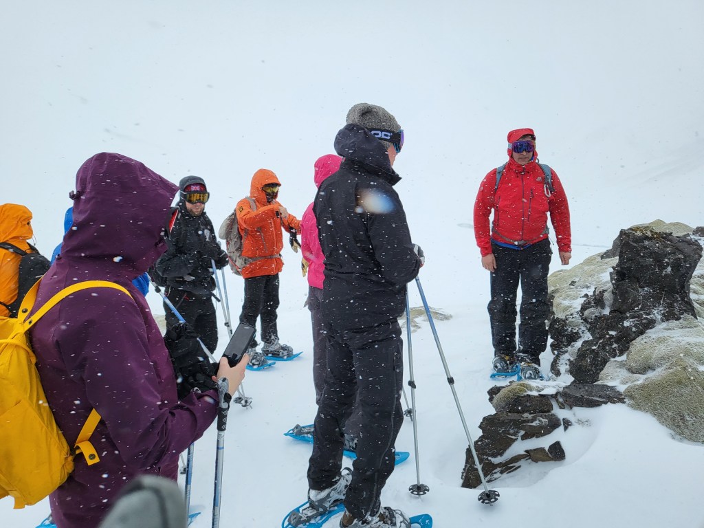 Group of trekkers out in a snowstorm.