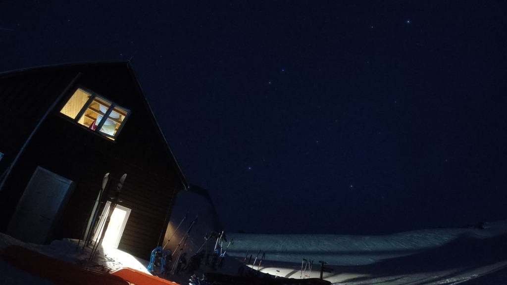 Night sky and stars outside a winter hut.